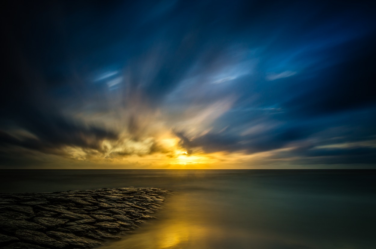 Golden sunset on windy day at the beach